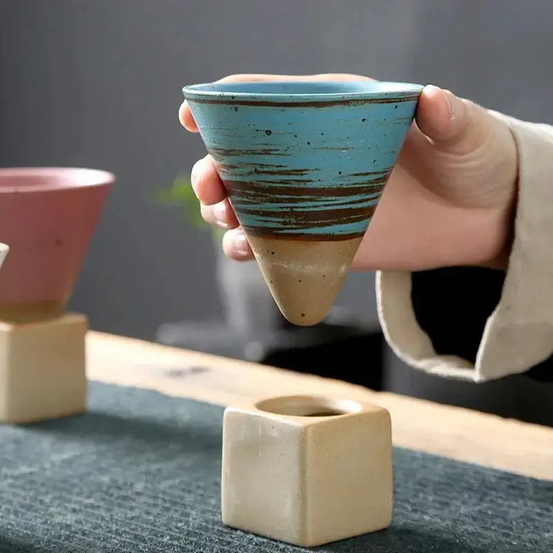 Japanese Retro Ceramic Coffee Cup held in hand, showcasing its unique design and color.