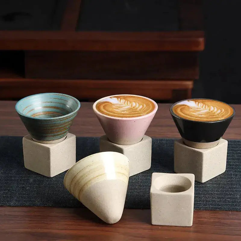 Japanese Retro Ceramic Coffee Cup set with four colorful mugs and stylish bases on a wooden table.