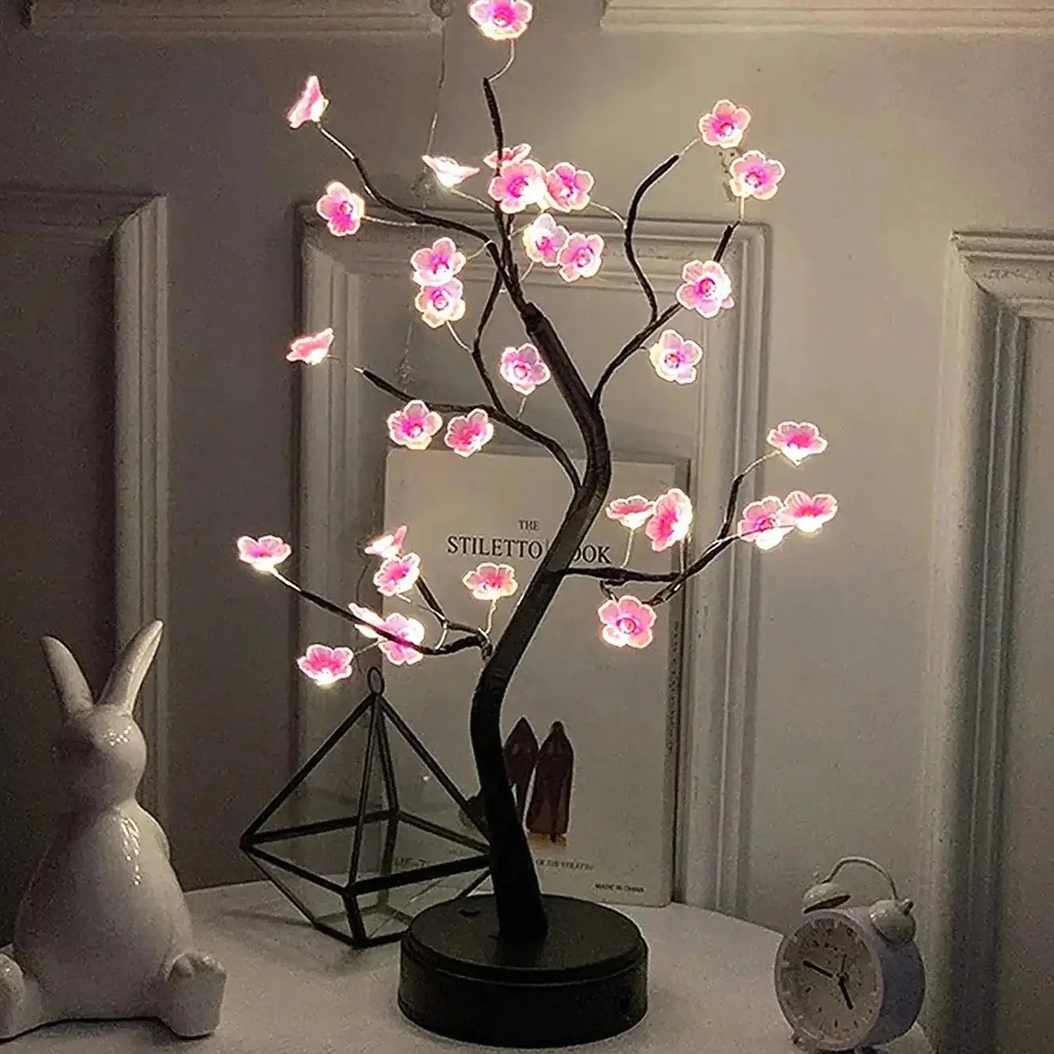 Cherry Blossom LED Bonsai Tree with illuminated flowers against a stylish backdrop, enhancing home decor.