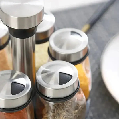 Glass Spice Rack Organizer Set with transparent spice jars and rotating tops for easy access.