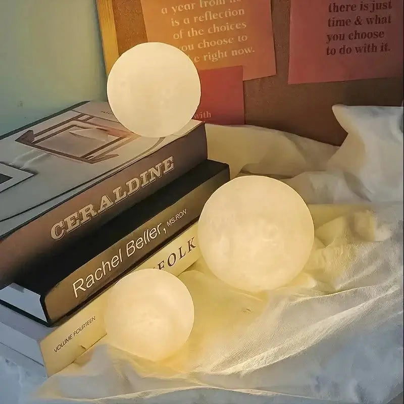 DIY Moon Light Night Kit on a table with books, featuring warm glowing spherical lamps.